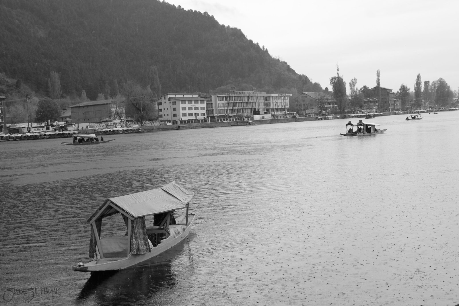 Dal Lake Srinagar Kashmir with Shikara and surrounding mountains